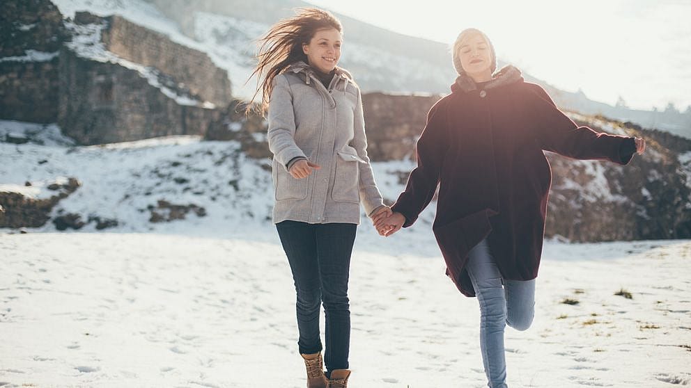 2 Freundinnen in den Bergen mit Schnee